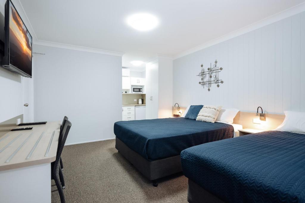 Postel nebo postele na pokoji v ubytování Raintree Motel Biloela