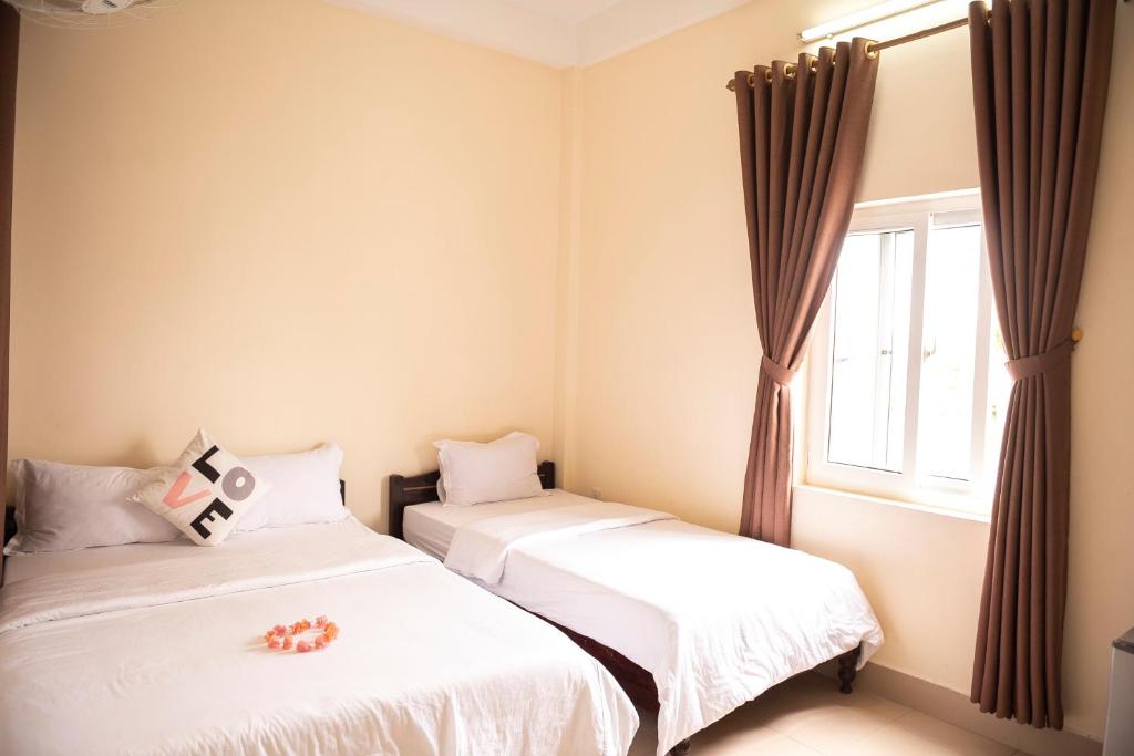 Postel nebo postele na pokoji v ubytování Minh Tam Guesthouse