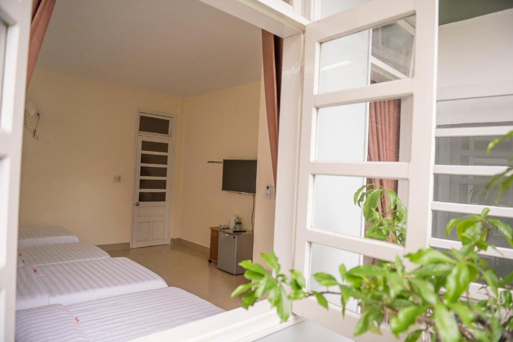 Postel nebo postele na pokoji v ubytování Minh Tam Guesthouse