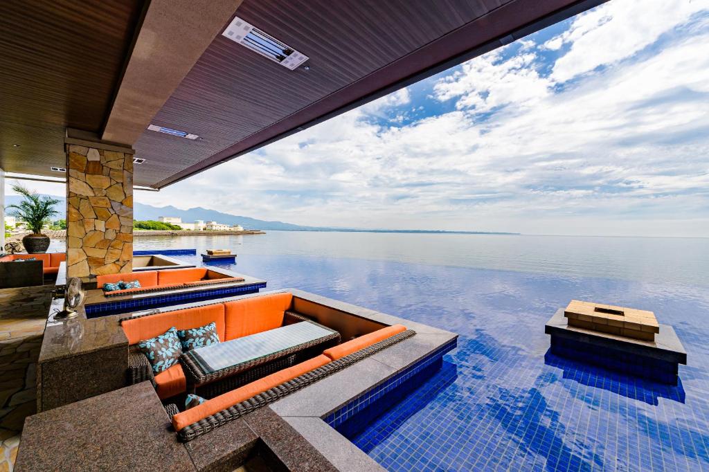 a house with a view of the water at AMANE resort SEIKAI in Beppu