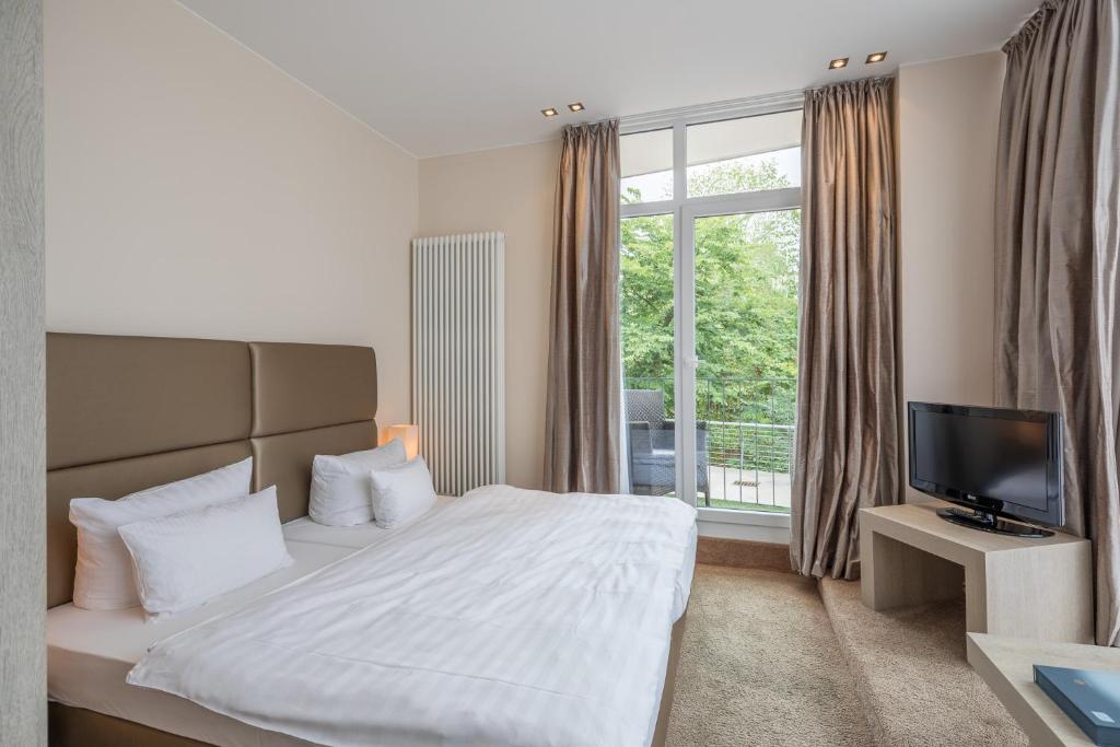 Postel nebo postele na pokoji v ubytování Thomas Hotel Spa & Lifestyle