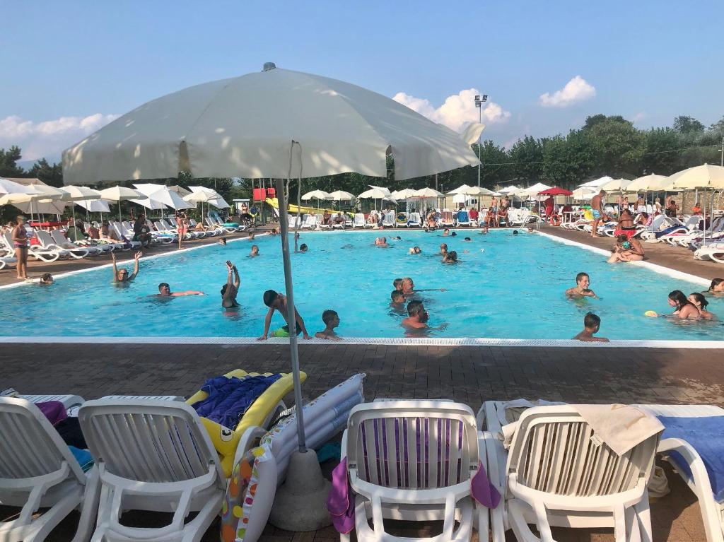 una piscina con molte persone in acqua di Apartment Rosa Cinderella a Lazise