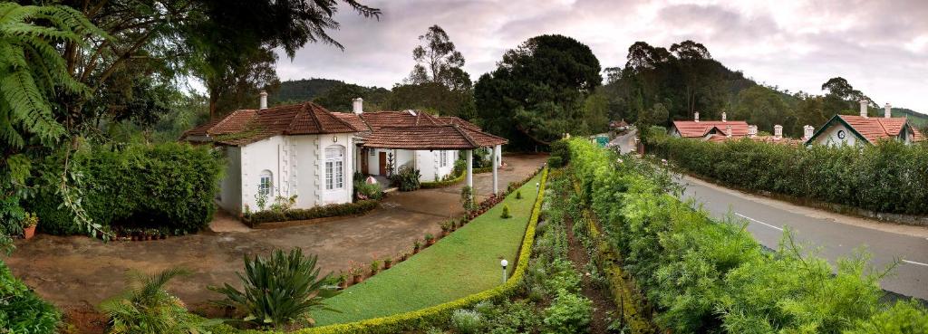 a small house on the side of a road at Neemrana's Wallwood Garden in Coonoor