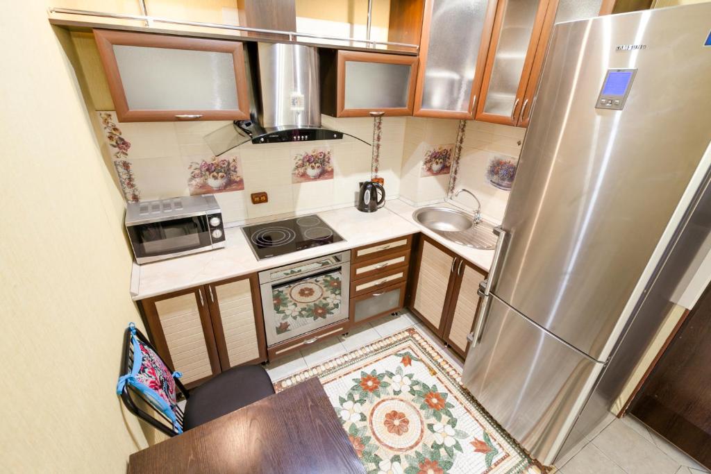 an overhead view of a small kitchen with a refrigerator at Центр! Папанинцев 111-157 in Barnaul