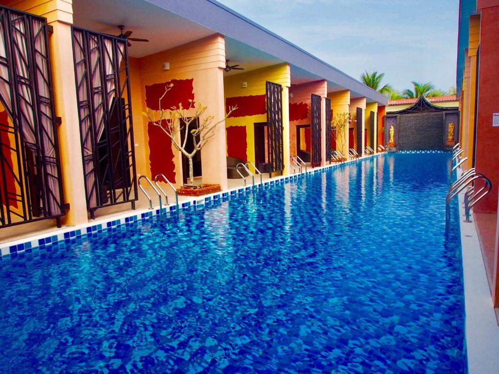 a large swimming pool in the middle of a building at Baan Noppadol Hua Hin Loft in Hua Hin