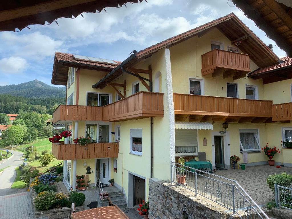 a large building with balconies and a street at Ferienwohnung Am Laitenhang in Lohberg