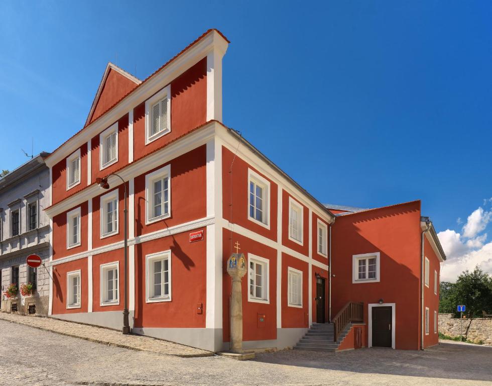 a large red and white building on a street at Hotel Garni Villa Areka in Český Krumlov