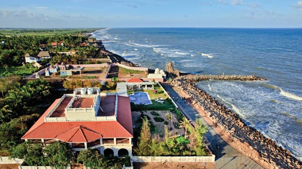an aerial view of a house next to the ocean at Neemrana's - Bungalow on The Beach in Tarangambādi
