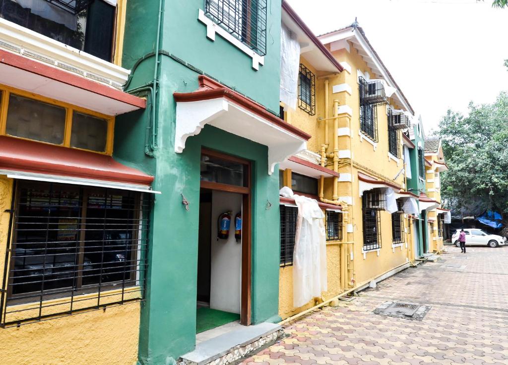 a row of colorful buildings on a street at Rama Krishna Hotel in Mumbai