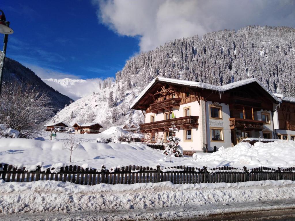 a house covered in snow in front of a mountain at Brollerhof in Neustift im Stubaital
