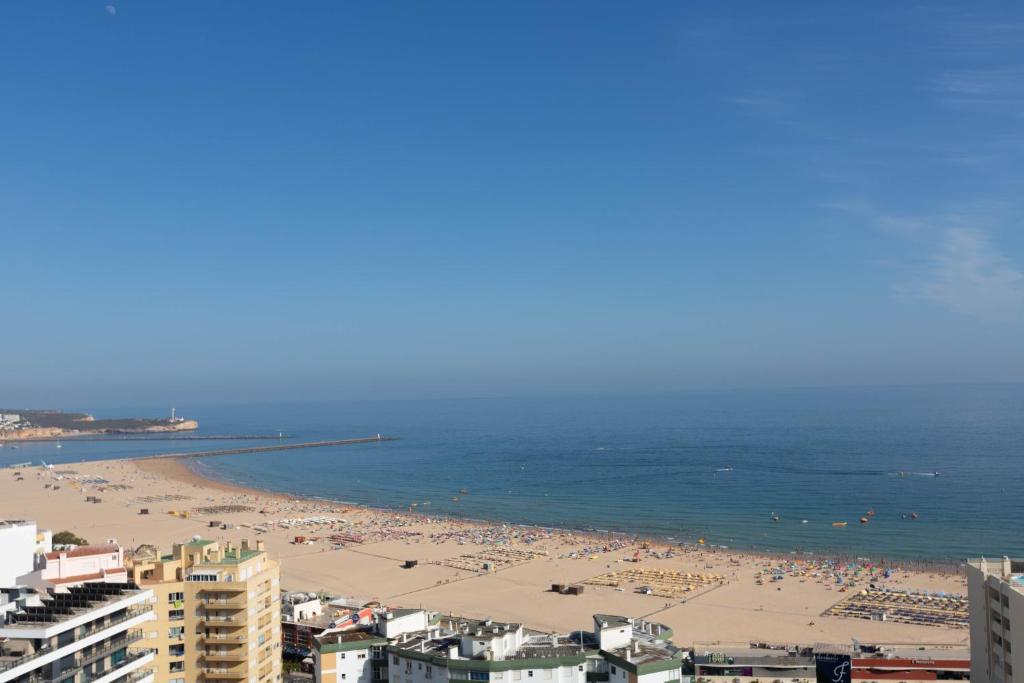 a view of a beach with a lot of people at SOLARIS PANORAMIC studio vue mer in Portimão