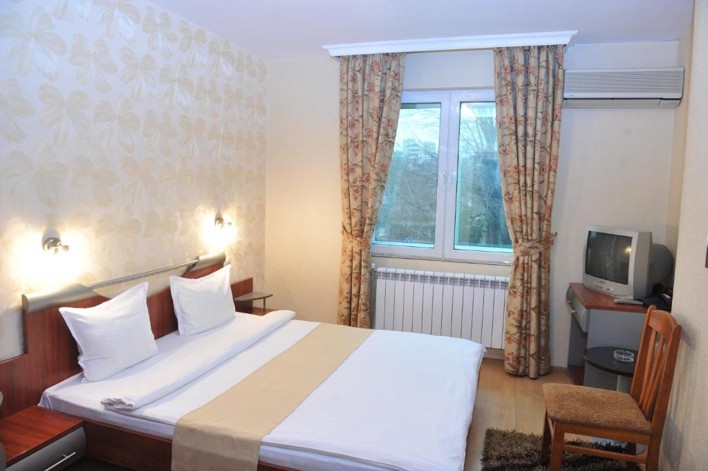 Postel nebo postele na pokoji v ubytování Eros Motel