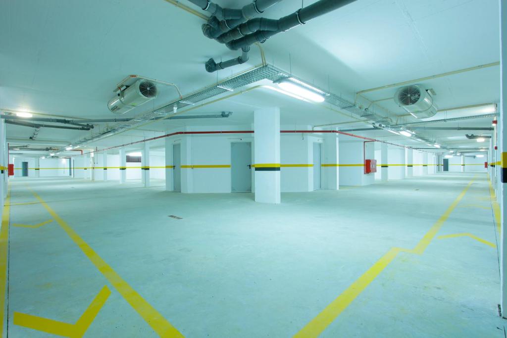 an empty parking lot with yellow lines in a parking garage at Sagres Time Apartamentos in Sagres