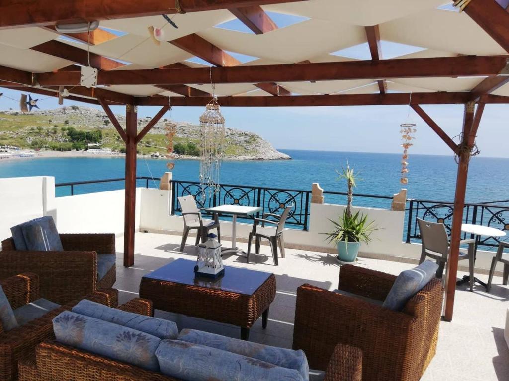 a patio with a view of the ocean at Haraki Beach in Haraki