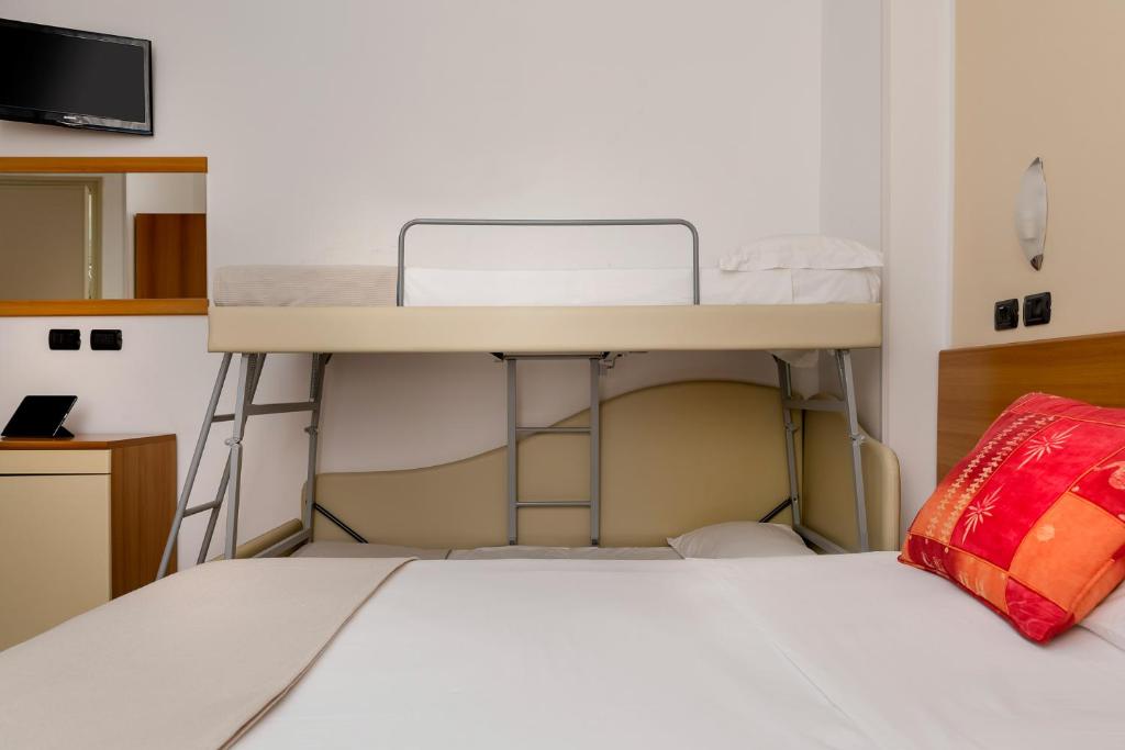 Postel nebo postele na pokoji v ubytování Hotel Maria Serena