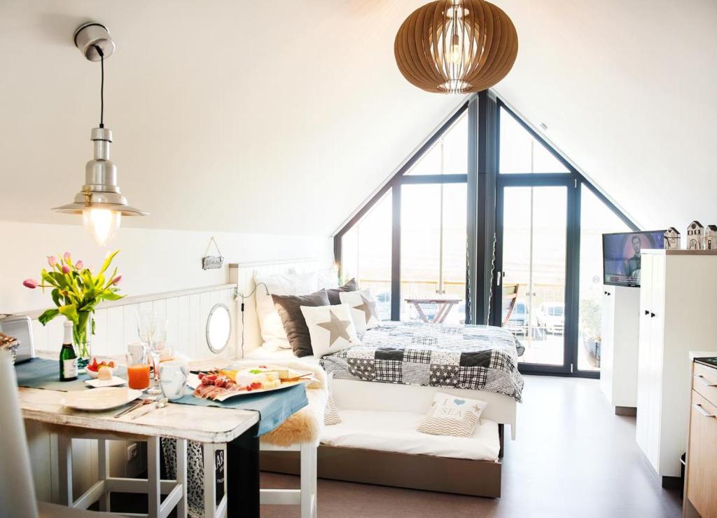 a kitchen and living room with a couch and a table at Perlekieker 2 in Büsum