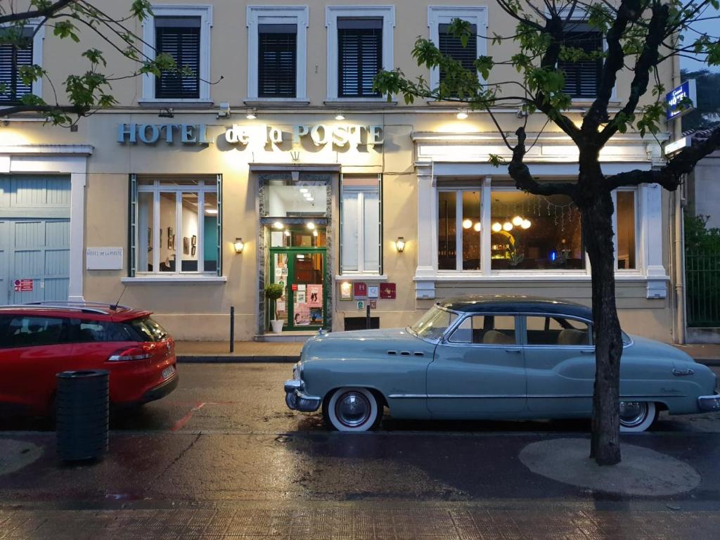 an old car parked in front of a store at Grand Hotel De La Poste - Lyon Sud - Vienne in Vienne