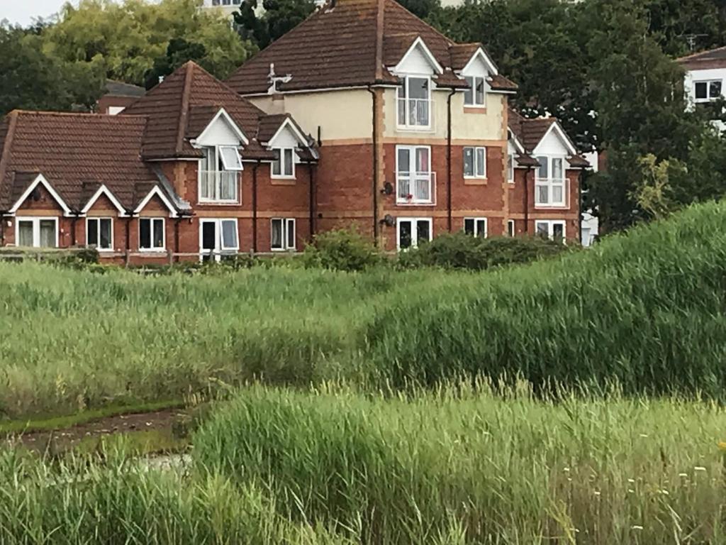 a large brick house in a field of grass at Weston Shore in Southampton