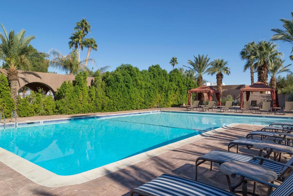 a swimming pool with chairs and a gazebo at Borrego Springs Resort and Spa in Borrego Springs