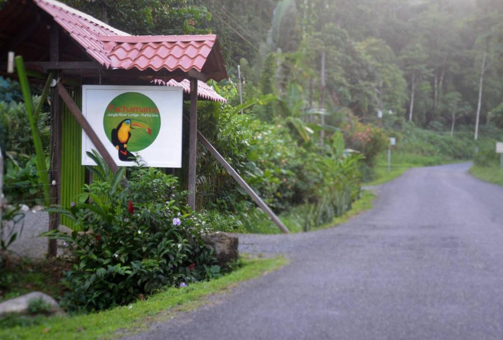 a sign on the side of a road at Pachamama Jungle River Lodge - Punta Uva in Puerto Viejo