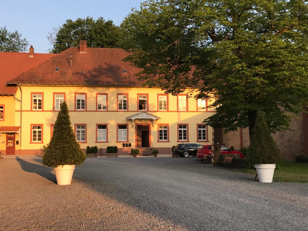 a large yellow building with a christmas tree in front of it at Elegantes Gästeapartment Verano in Schloß und Hofgut Langenzell in Wiesenbach