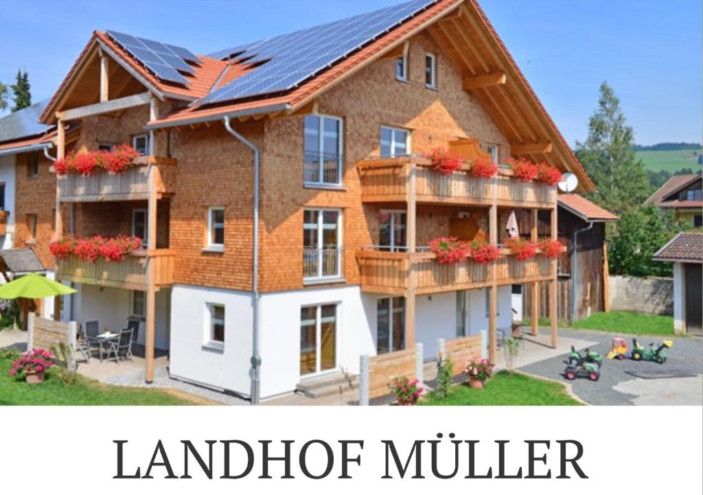 a house with a solarium on top of it at Landhof Müller in Wertach