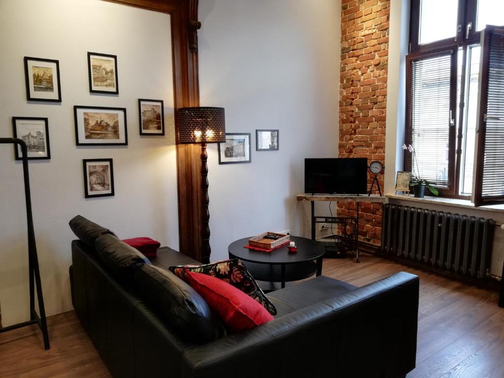 uma sala de estar com um sofá e uma mesa em Apartamenty Bydgostia em Bydgoszcz