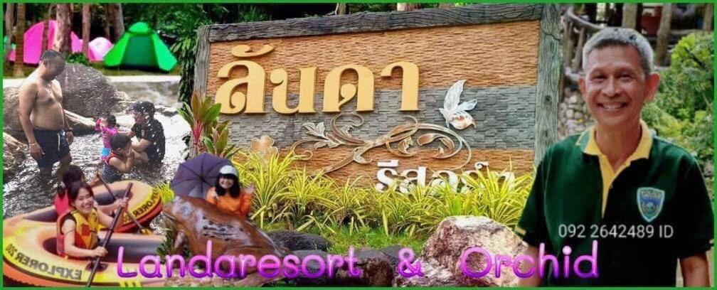 a boy standing in front of an animal kingdom sign at Lunda Orchid Resort in Suan Phung