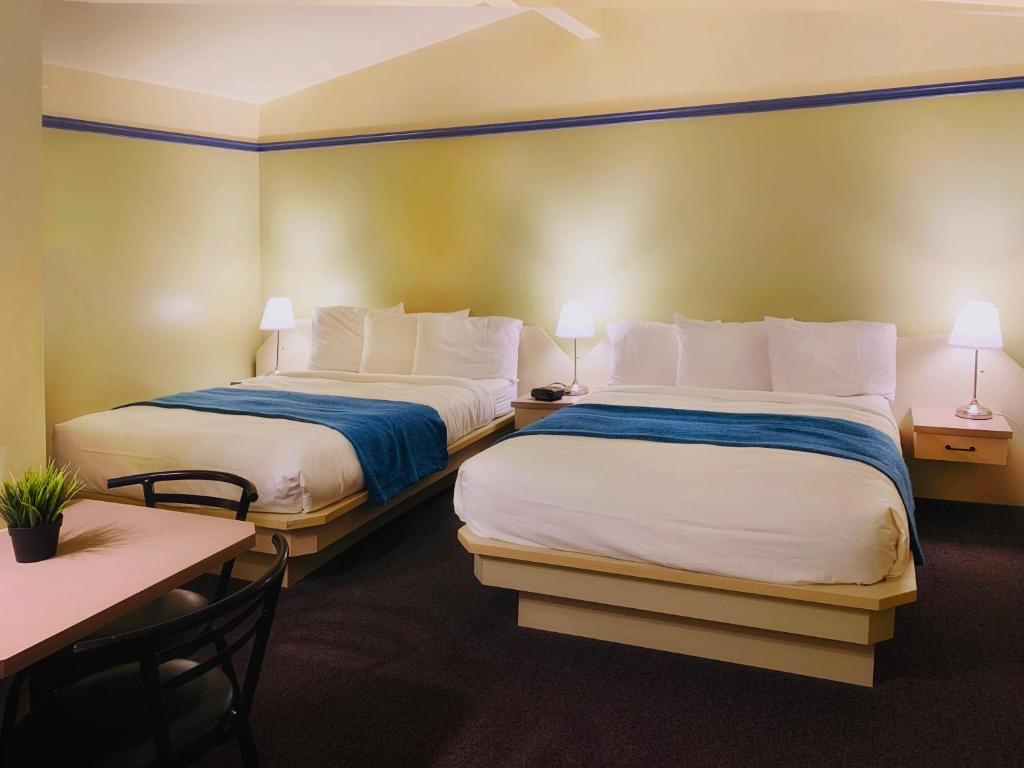 Postel nebo postele na pokoji v ubytování Motel La Cheminée