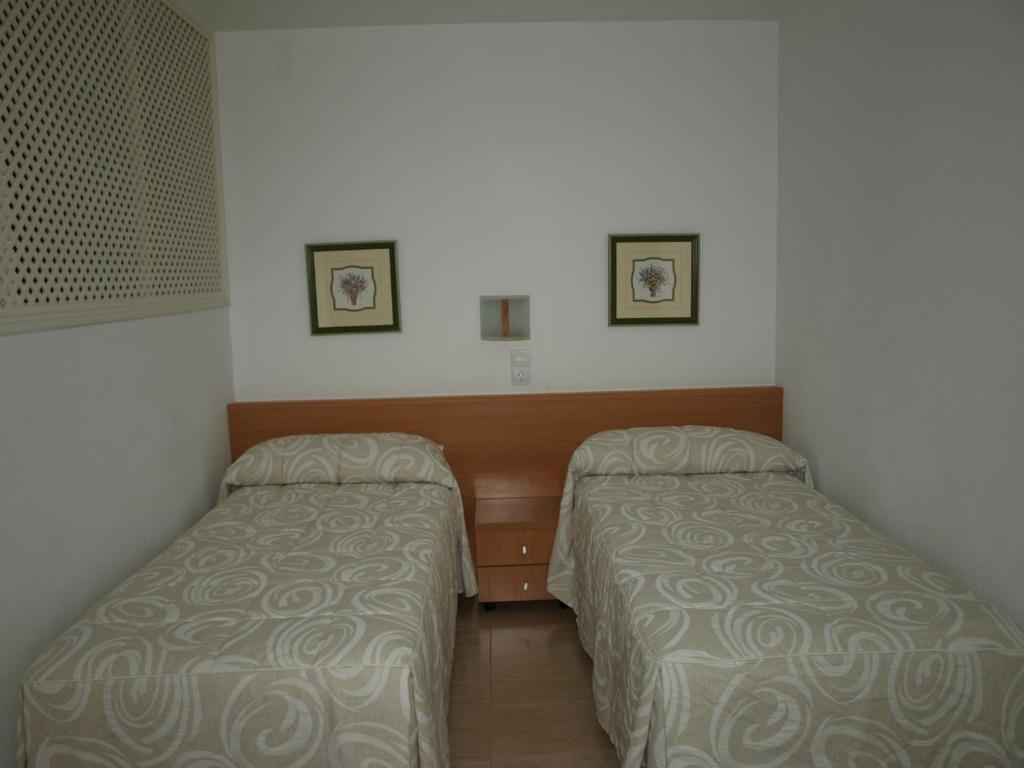 Postel nebo postele na pokoji v ubytování Apartaments Geminis