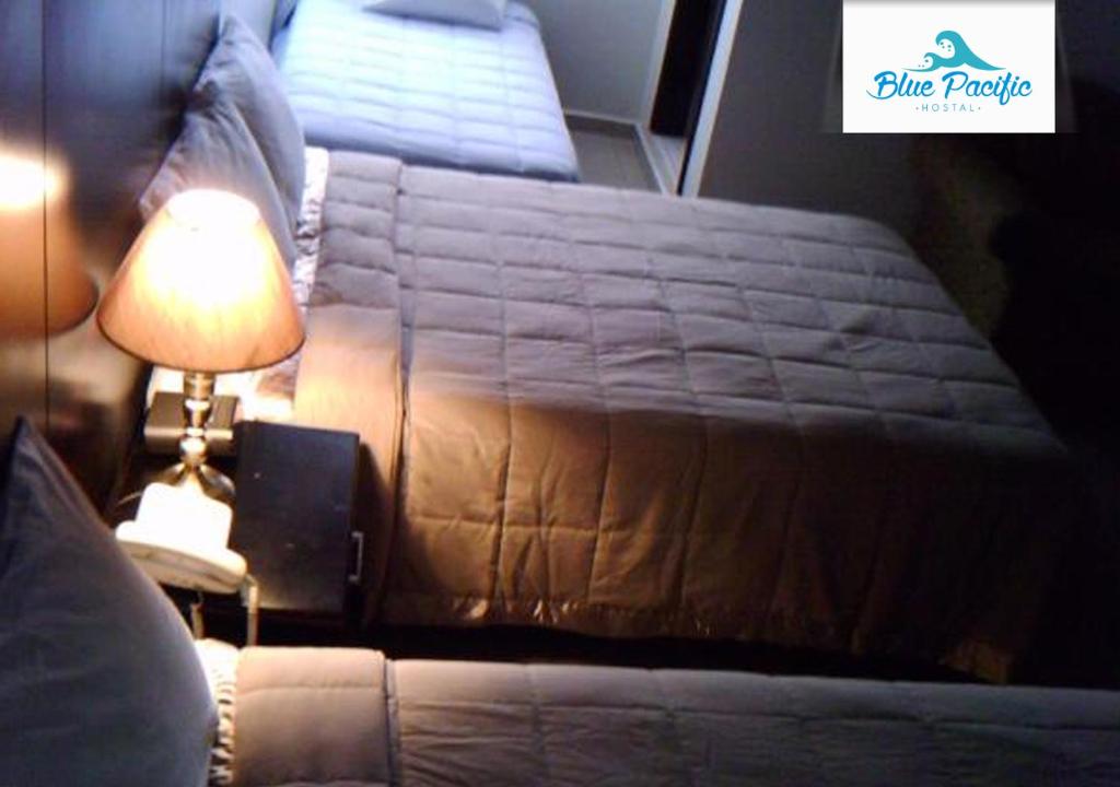 Postel nebo postele na pokoji v ubytování Hostal Blue Pacific