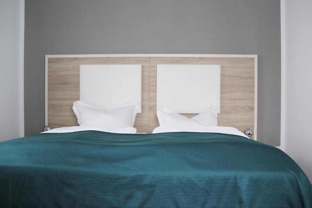 Postel nebo postele na pokoji v ubytování Stadthotel Alsfeld
