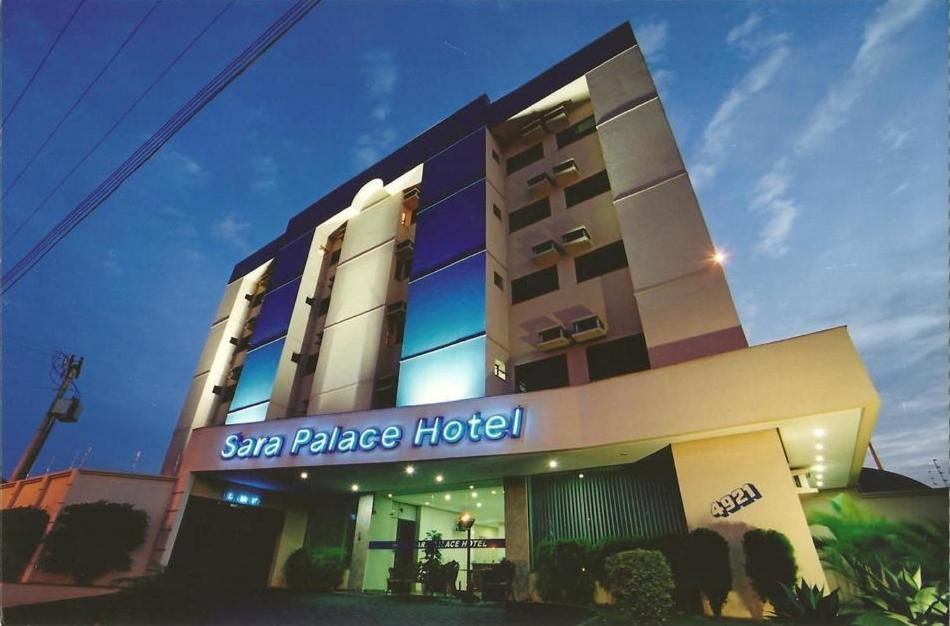 a sahar palace hotel is lit up at night at Sara Palace Hotel in Uberlândia