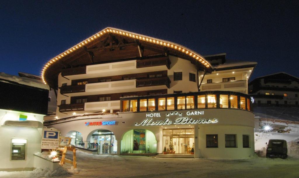 a building with lights on top of it at night at Hotel Garni Monte Bianco in Ischgl