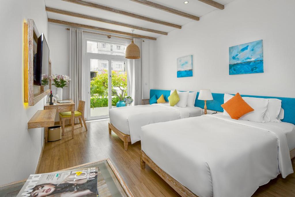 Giường trong phòng chung tại Risemount Premier Resort Da Nang