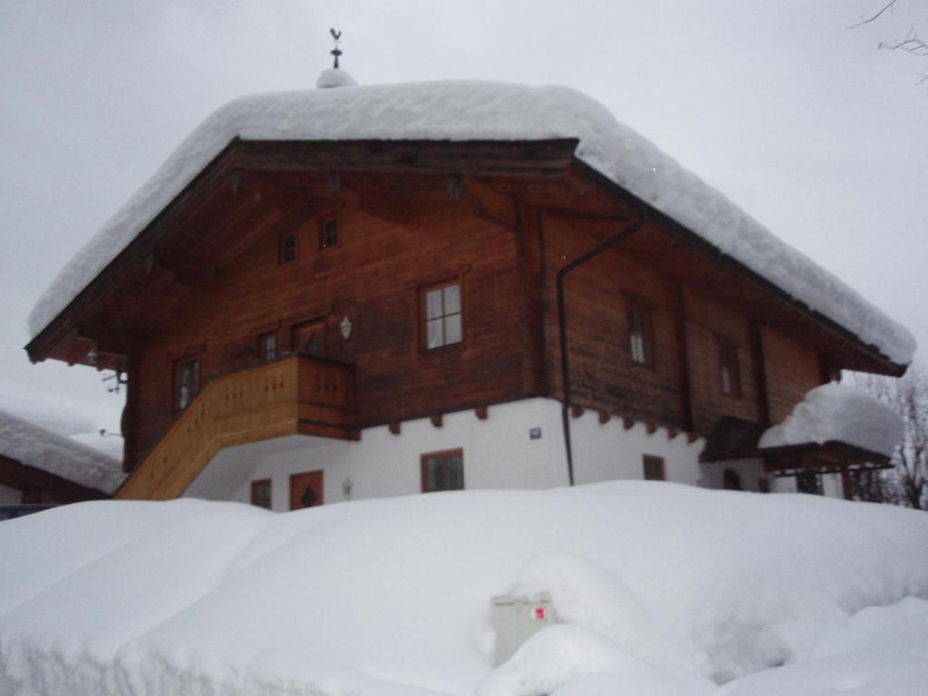 a large wooden house covered in snow at Ski apartment St. Johann in Tirol, Kitzbuheler Alpen in Sankt Johann in Tirol