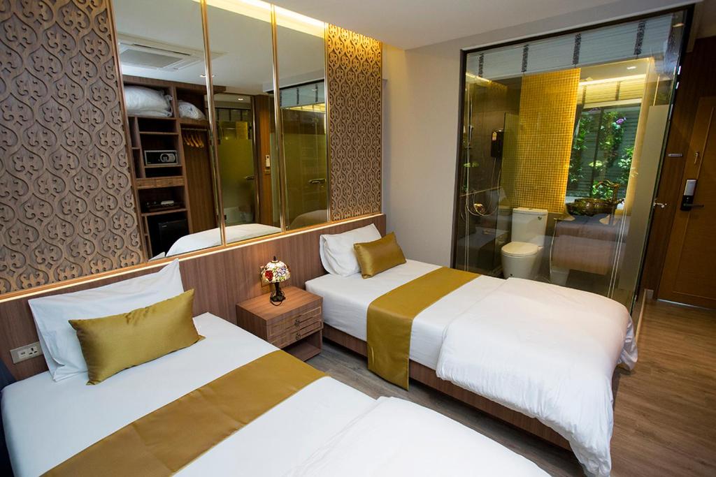 a hotel room with two beds and a shower at GHEE GELATO HOUSE in Bangkok