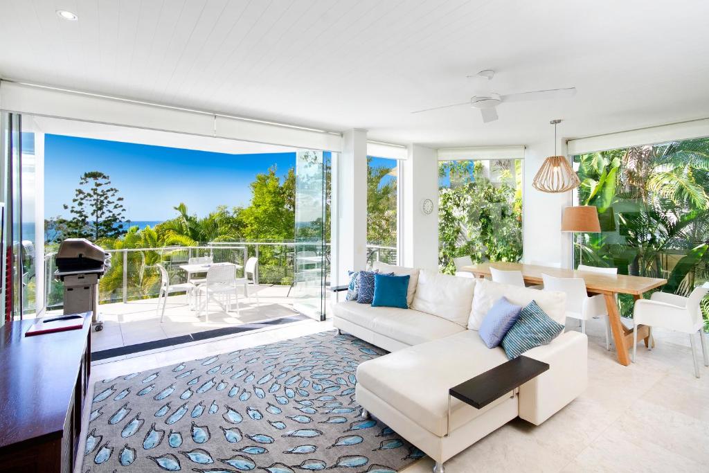 a living room with a couch and a table at Allambi Apartment 1, 25 Allambi Rise, Little Cove in Noosa Heads