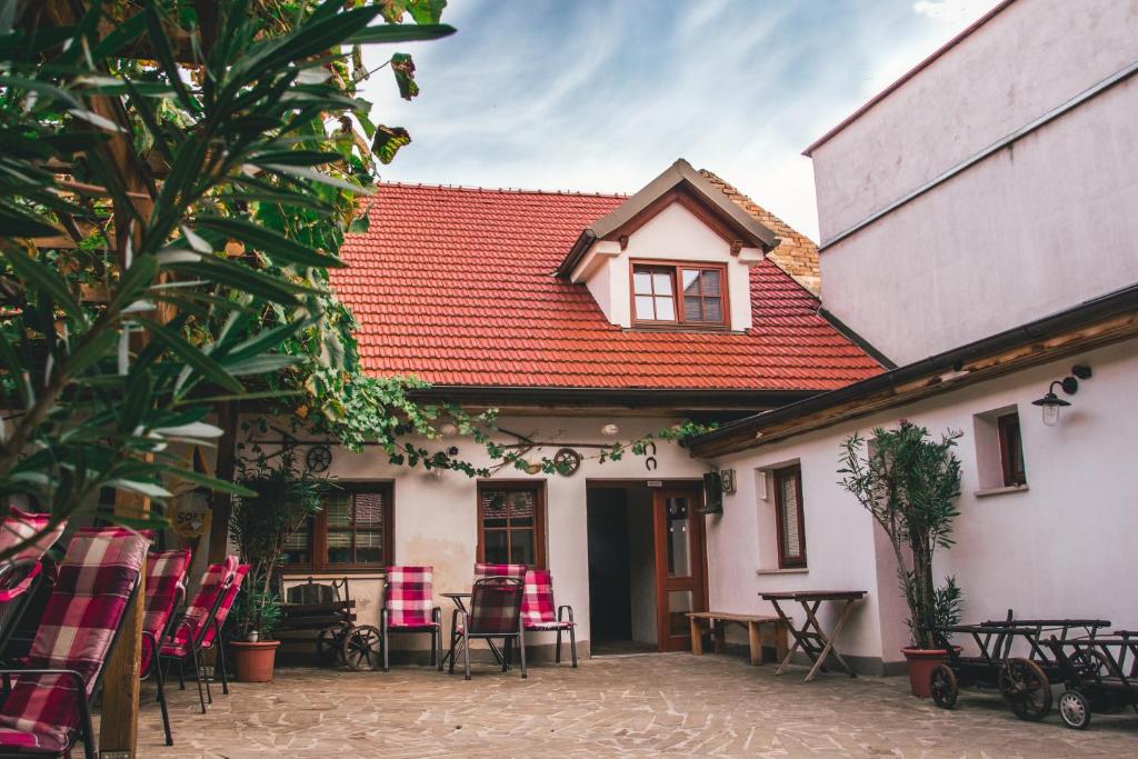 a house with a red roof and tables and chairs at Apartmán Alva 3 in Mikulov