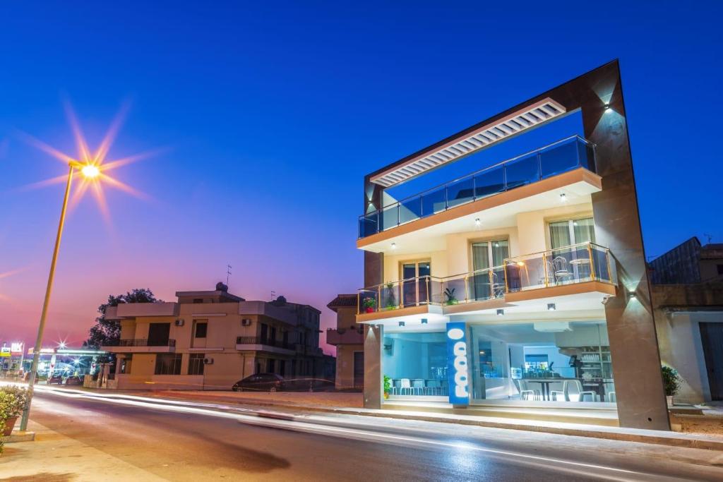 a building on the side of a street at night at Mediterraneo Palace Luxury Affittacamere in Pachino