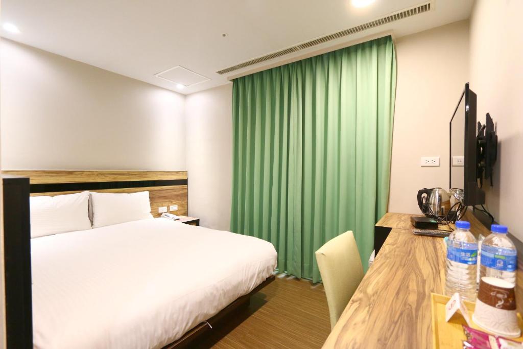 Voodi või voodid majutusasutuse 鼎立安商務旅館 Dinglian Hotel toas