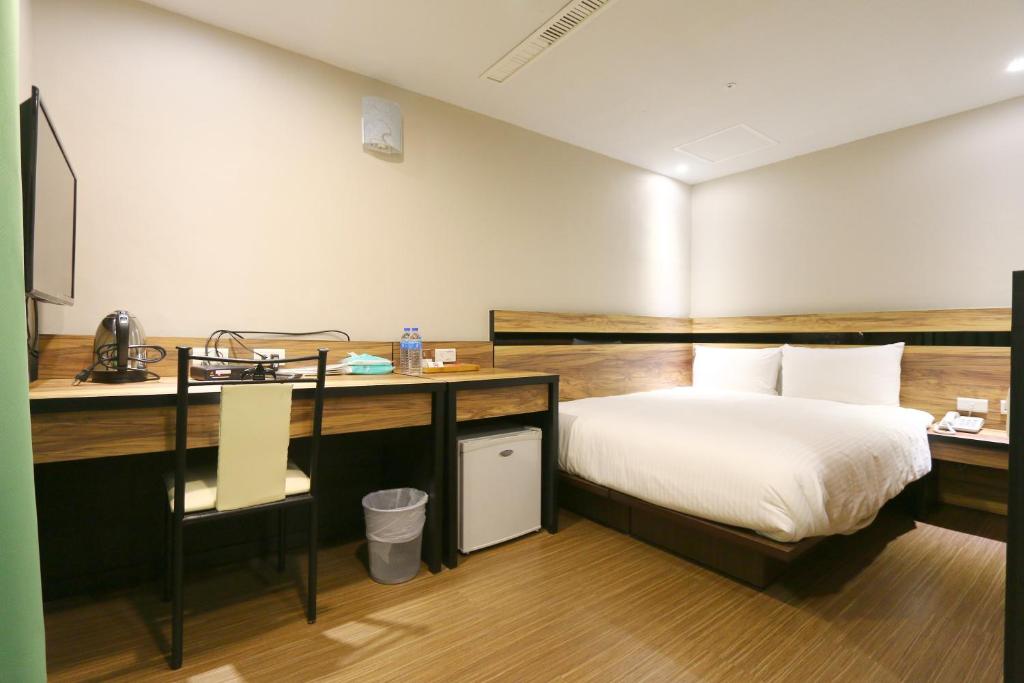 Voodi või voodid majutusasutuse 鼎立安商務旅館 Dinglian Hotel toas
