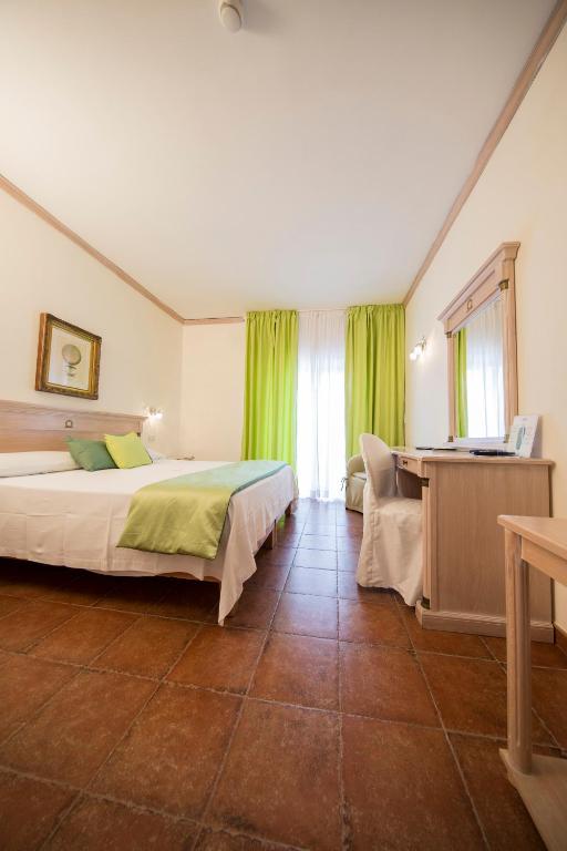 Postel nebo postele na pokoji v ubytování Mancini Park Hotel