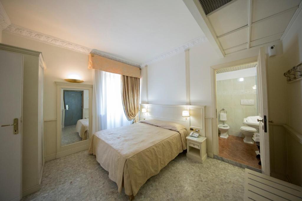 Postel nebo postele na pokoji v ubytování Mancini Park Hotel