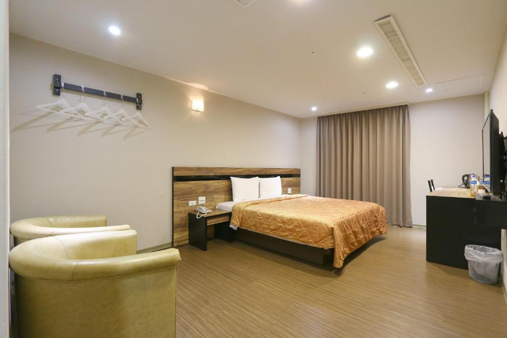 Voodi või voodid majutusasutuse 鼎立安商務旅館 Dinglian Hotel toas