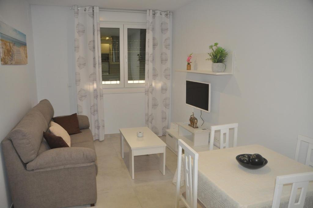 a living room with a couch and a table at APARTAMENTO ICEBERG TARIFA in Tarifa