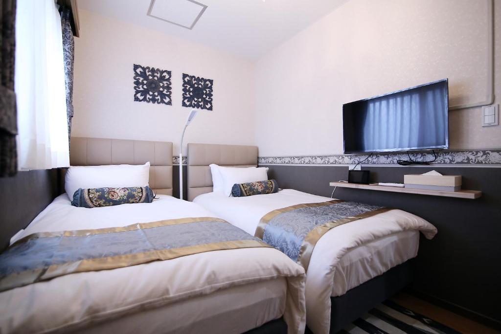 Postel nebo postele na pokoji v ubytování SHINJUKU GLOBAL HOTEL