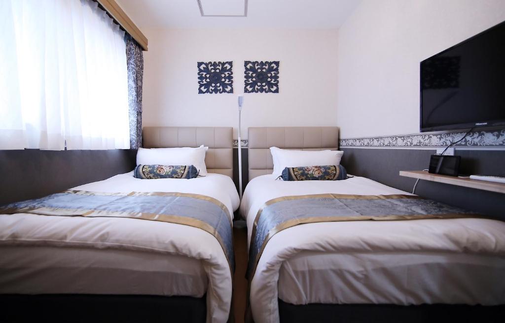 Postel nebo postele na pokoji v ubytování SHINJUKU GLOBAL HOTEL