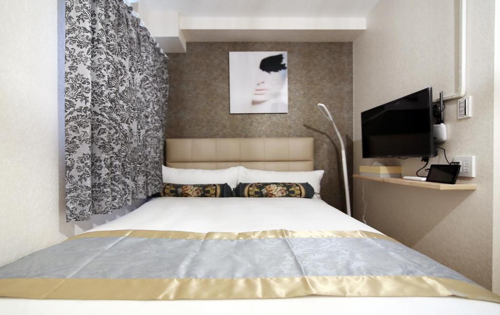 Postel nebo postele na pokoji v ubytování SHINJUKU GLOBAL HOTEL