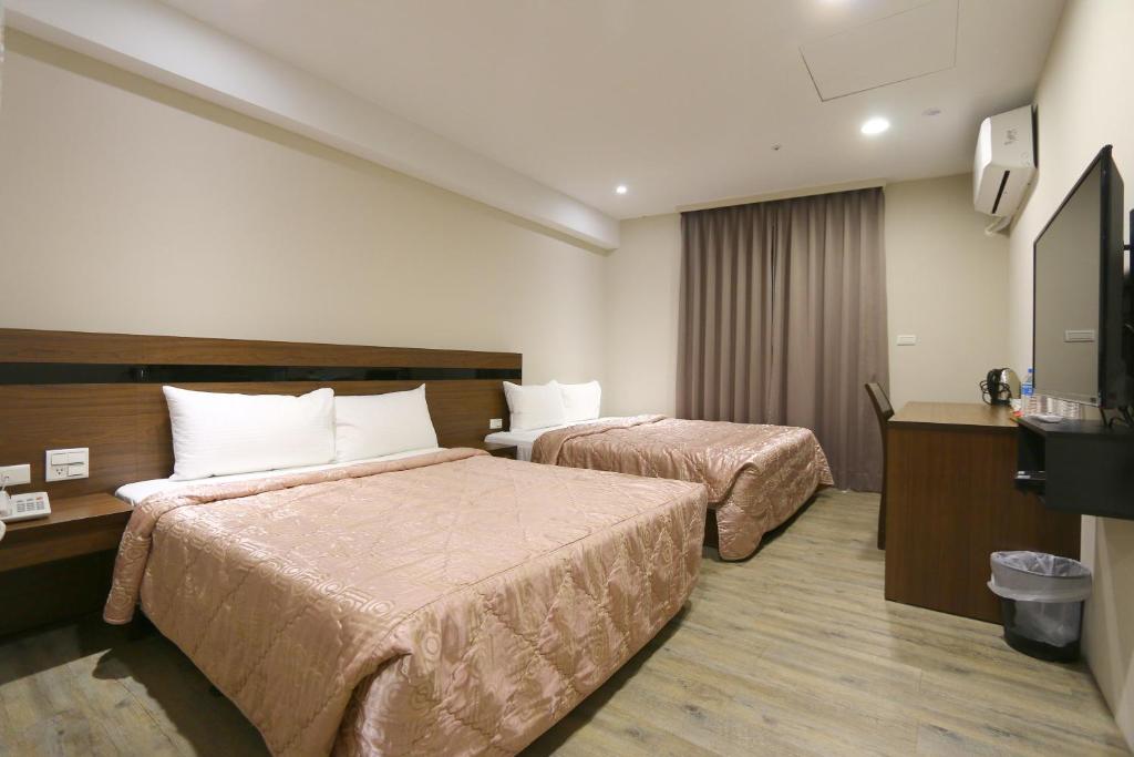 Voodi või voodid majutusasutuse 鼎立安商務旅館 Dinglian Hotel toas